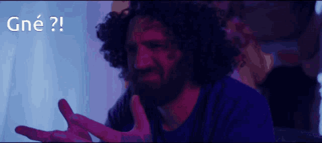 a man with a beard is making a funny face and the words gne are behind him