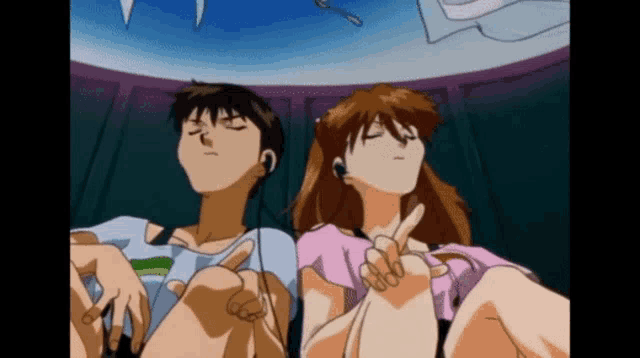 a man and a woman are sitting next to each other with their eyes closed .