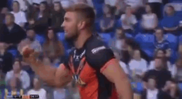 a blurry picture of a group of people hugging each other in a stadium .