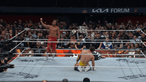 a wrestler in a ring with a sign that says " aew " on it
