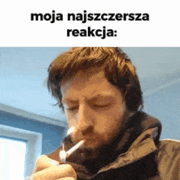 a man with a beard is lighting a cigarette with a lighter