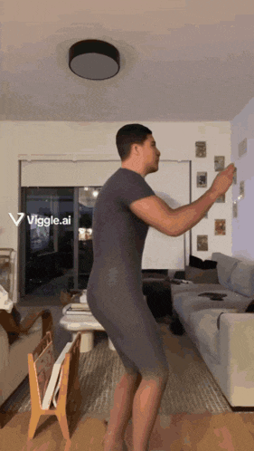 a man is dancing in a living room with a viggle.ai sticker on the wall