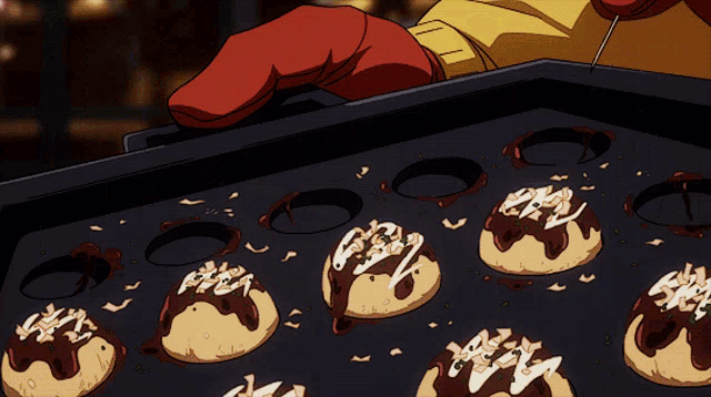 a person in a red glove is holding a pan of cookies