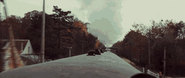 a train is going down a track with trees on the side