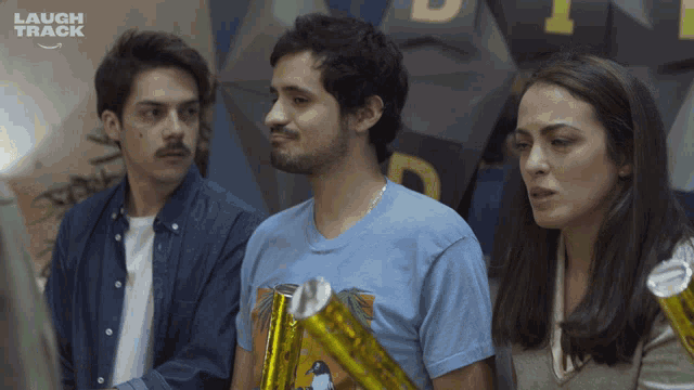 a group of people standing in front of a sign that says laugh track on it