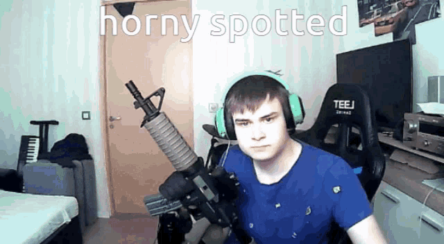 a man wearing headphones and holding a gun with horny spotted written on the bottom
