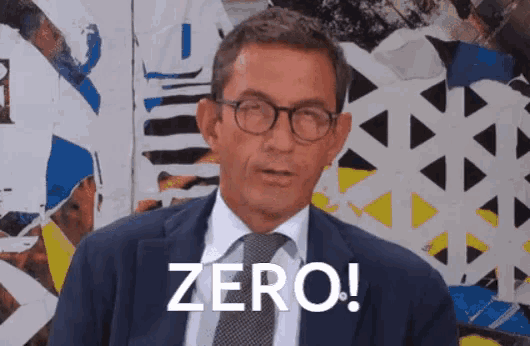 a man in a suit and tie says zero in white letters