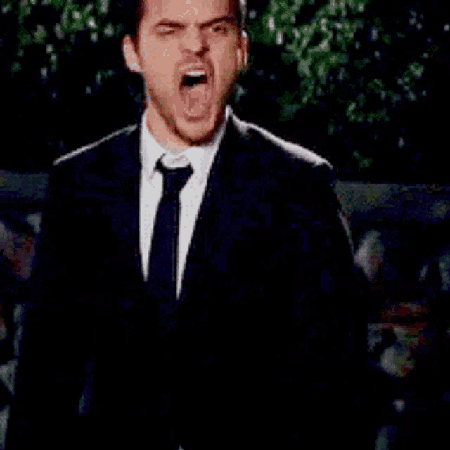 a man in a suit and tie is looking up