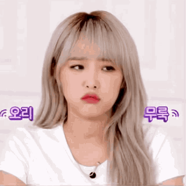 a woman with blonde hair is making a funny face .