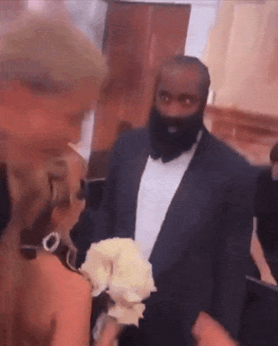 a man with a beard is standing next to a woman in a dress