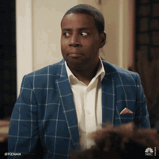 a man in a blue plaid suit has the hashtag #kenan on his sleeve