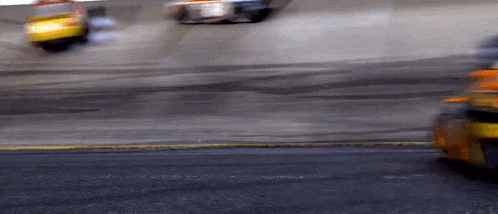 a blurry picture of a race car going down the track
