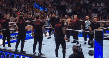 a group of men standing in a wrestling ring with a sign that says salt lake city on it