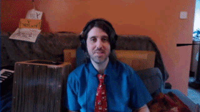 a man wearing headphones and a tie is dancing