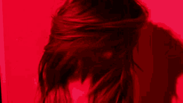 a blurry picture of a woman in a red light
