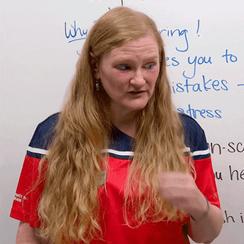 a woman stands in front of a white board that says " why ring "