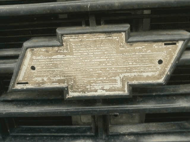 a close up of a chevrolet emblem on a black grille