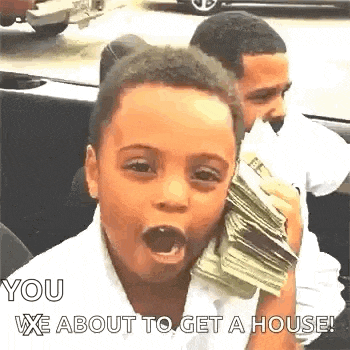 a young boy is holding a pile of money in his mouth .
