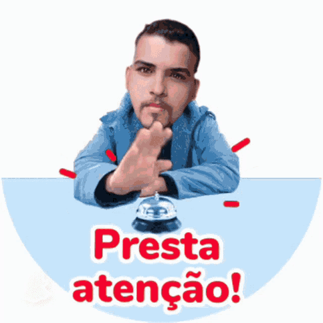a man is sitting at a table with a bell and the words presta atenção