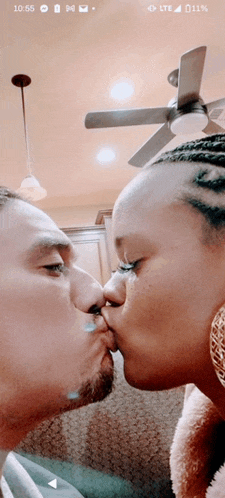 a man and a woman kissing with the time 10:55