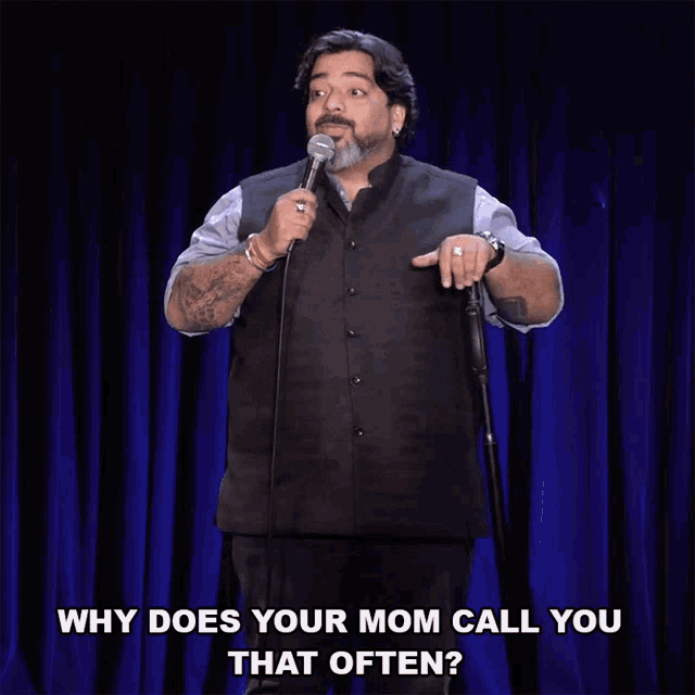 a man stands in front of a microphone with the words why does your mom call you that often