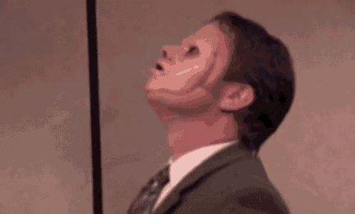 a woman is screaming in a crowd of people while sitting in a chair .