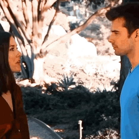 a man and a woman are standing next to each other and talking to each other