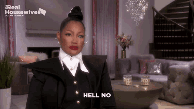 a woman sitting in a living room with the words hell no on her face