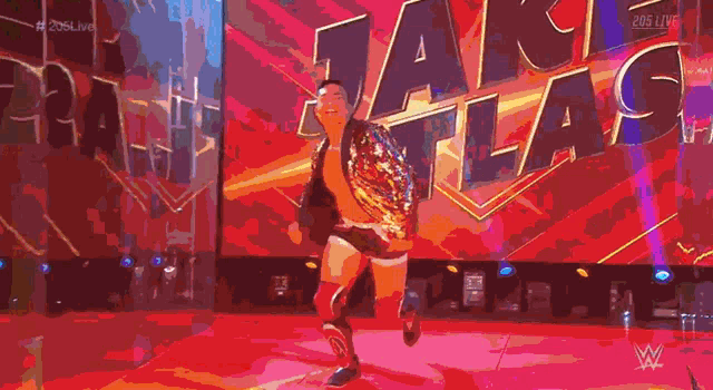 a man in a wrestling ring holding a championship belt