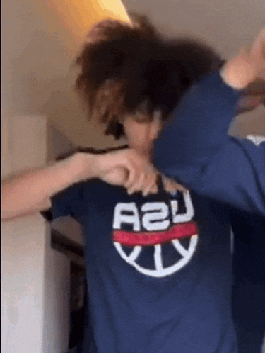 a person wearing a blue shirt with a2u on it