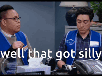 two store employees are sitting at a desk with a box of tissues and the words well that got silly