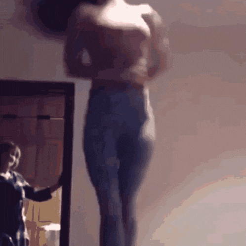 a woman is standing in front of a mirror with her arms outstretched