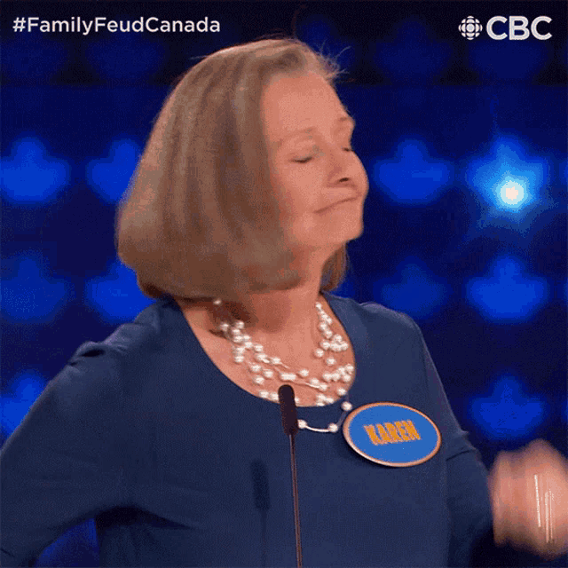 a woman wearing a blue shirt with a name tag that says karen
