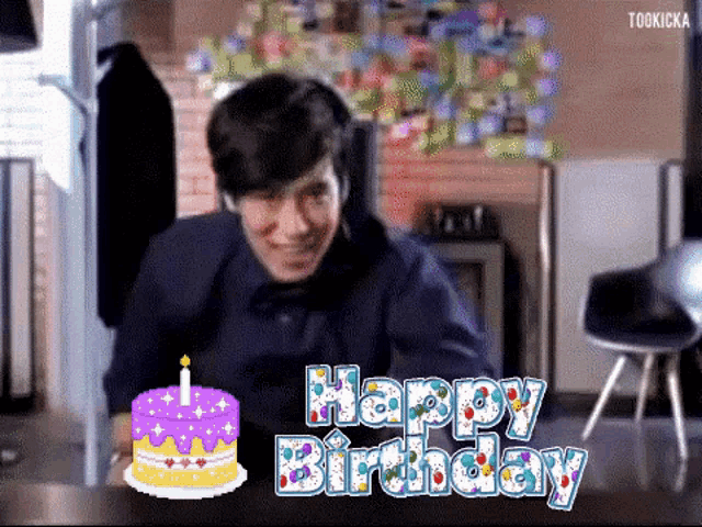 a man sitting at a table with a birthday cake and the words happy birthday