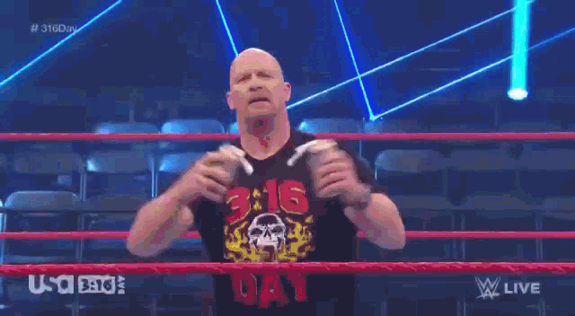 a man is screaming in a wrestling ring with a blue background and the word live on the bottom
