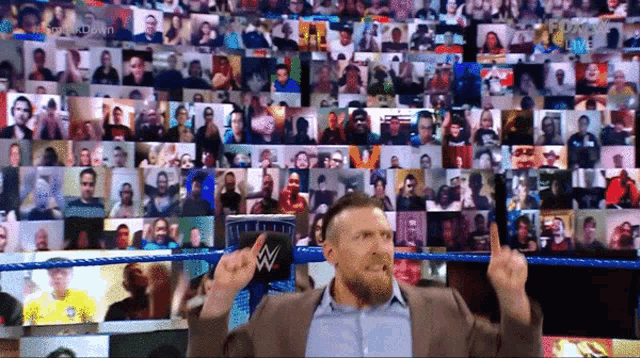 a man in a wrestling ring giving a thumbs up