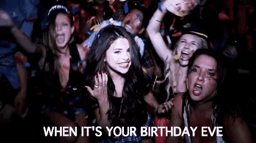 a group of women are sitting in a crowd at a birthday party .