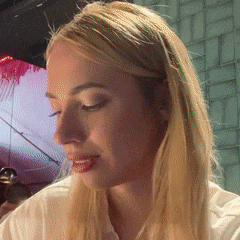 a woman with blonde hair is looking down at something