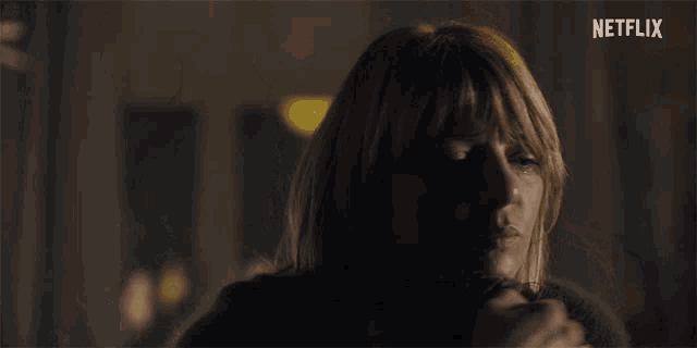 a close up of a woman 's face with netflix written on the bottom