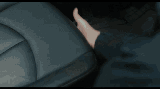a man is reaching out to open a car door with his finger