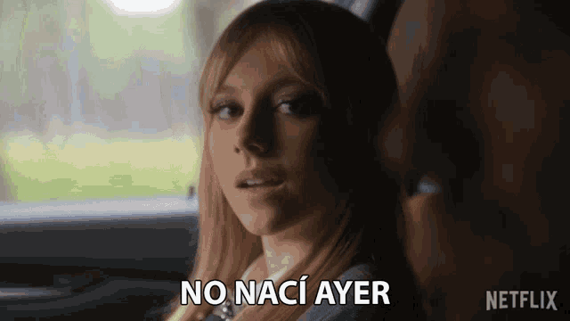 a woman in a car says " no naci ayer " in spanish