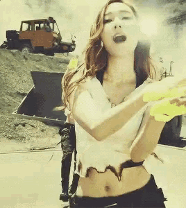 a woman in a white top is holding a yellow object
