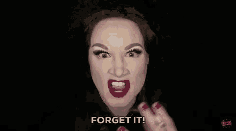 a woman with red lipstick and red nails is making a funny face .