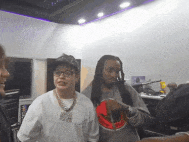 a man with dreadlocks is wearing a white shirt that says supreme on it