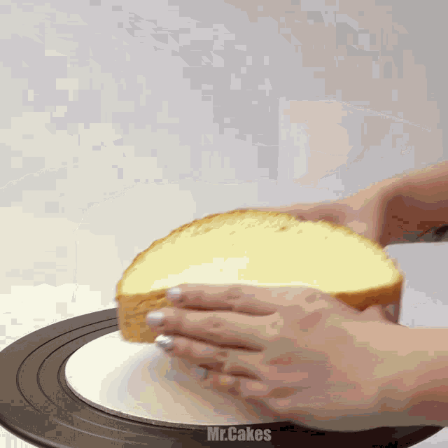 a person is holding a piece of bread on a plate that says mr.cakes on it