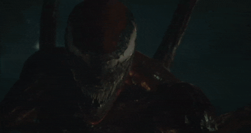 a close up of a venom monster 's mouth with its tongue sticking out .