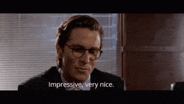 a man in a suit and tie is saying impressive very nice