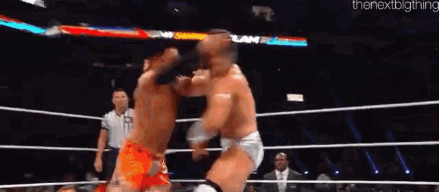 two wrestlers are fighting in a ring and the next big thing is on the bottom