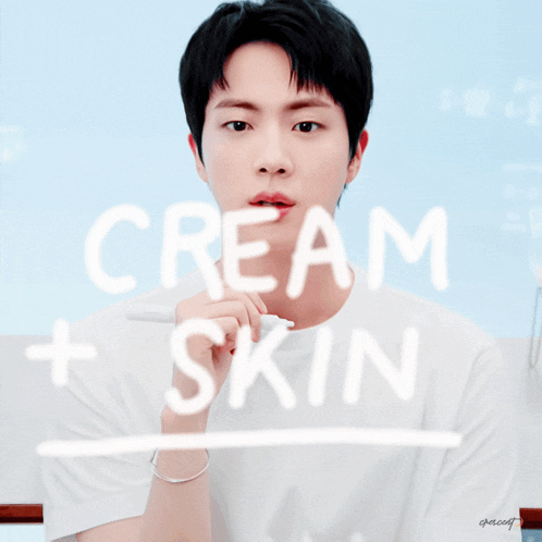 a young man is behind a sign that says cream skin
