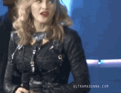a woman in a black leather jacket with the website ultramadonna.com